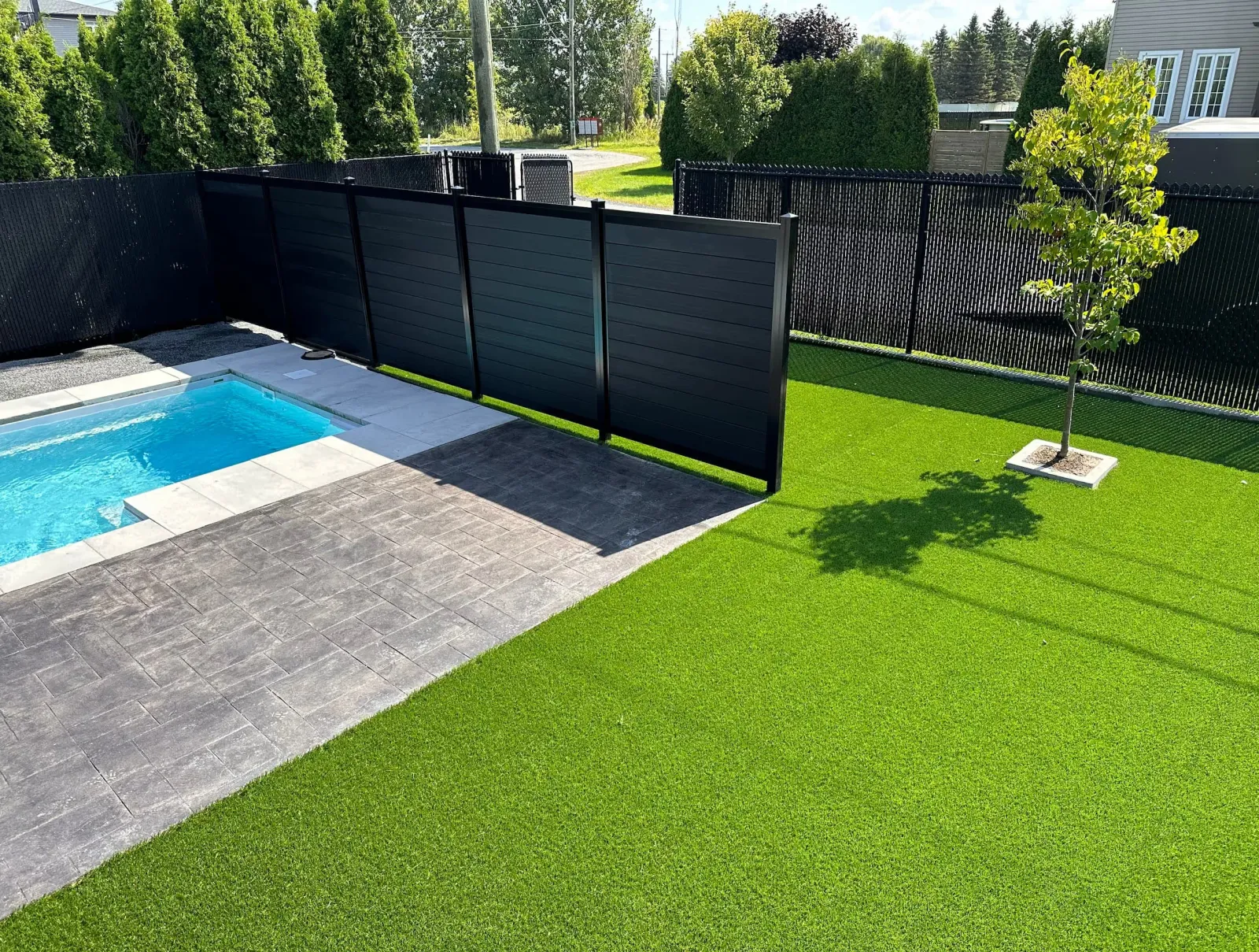 Black composite fence in a backyard